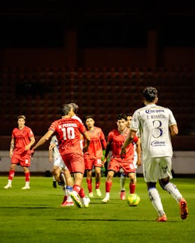 Players in action during a night football game in Tlaxcala, Mexico.