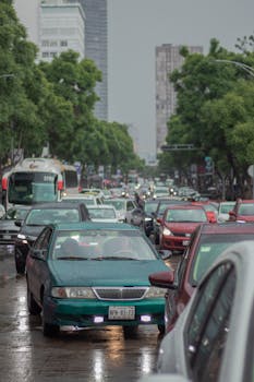 Traffic jam in Mexico City with vehicles on a rainy day, displaying urban congestion.